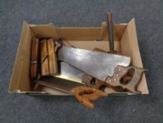 A box containing vintage woodworking planes, hand saws, wooden mallet etc.