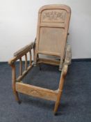 An Edwardian oak adjustable armchair.