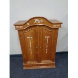 A pine double door cabinet fitted drawer beneath bearing Fry's advertisement