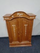 A pine double door cabinet fitted drawer beneath bearing Fry's advertisement