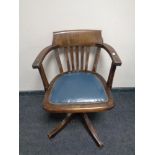 An Edwardian oak desk armchair