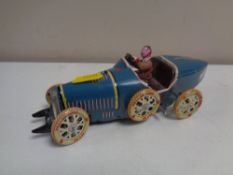 A 20th century tin plate racing car with Ballon Cord tyres.