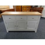 A contemporary oak topped triple door sideboard