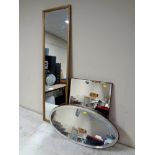 Two 20th century frameless bevelled mirrors together with a gilt framed hall mirror.