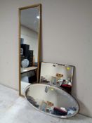 Two 20th century frameless bevelled mirrors together with a gilt framed hall mirror.