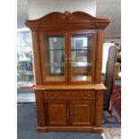 An American style double door display cabinet fitted with cupboards and drawers