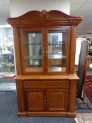 An American style double door display cabinet fitted with cupboards and drawers
