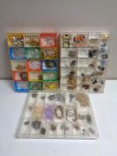 Three plastic display cases containing a large quantity of assorted costume jewellery to include