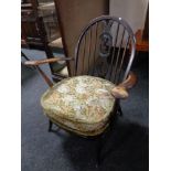 An Ercol elm and beech armchair in antique finish