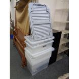 A quantity of plastic storage boxes with lids.