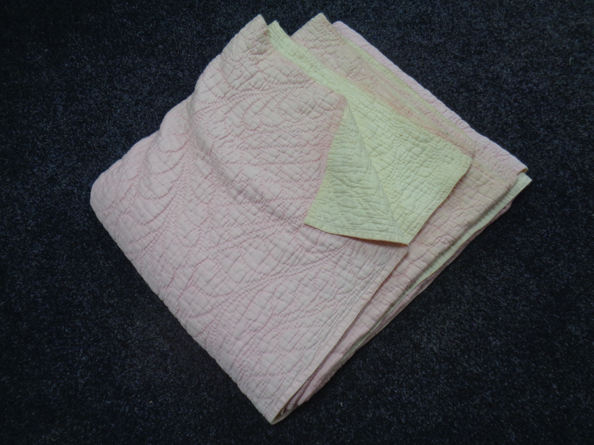 A hand stitched Durham quilt - pink and cream