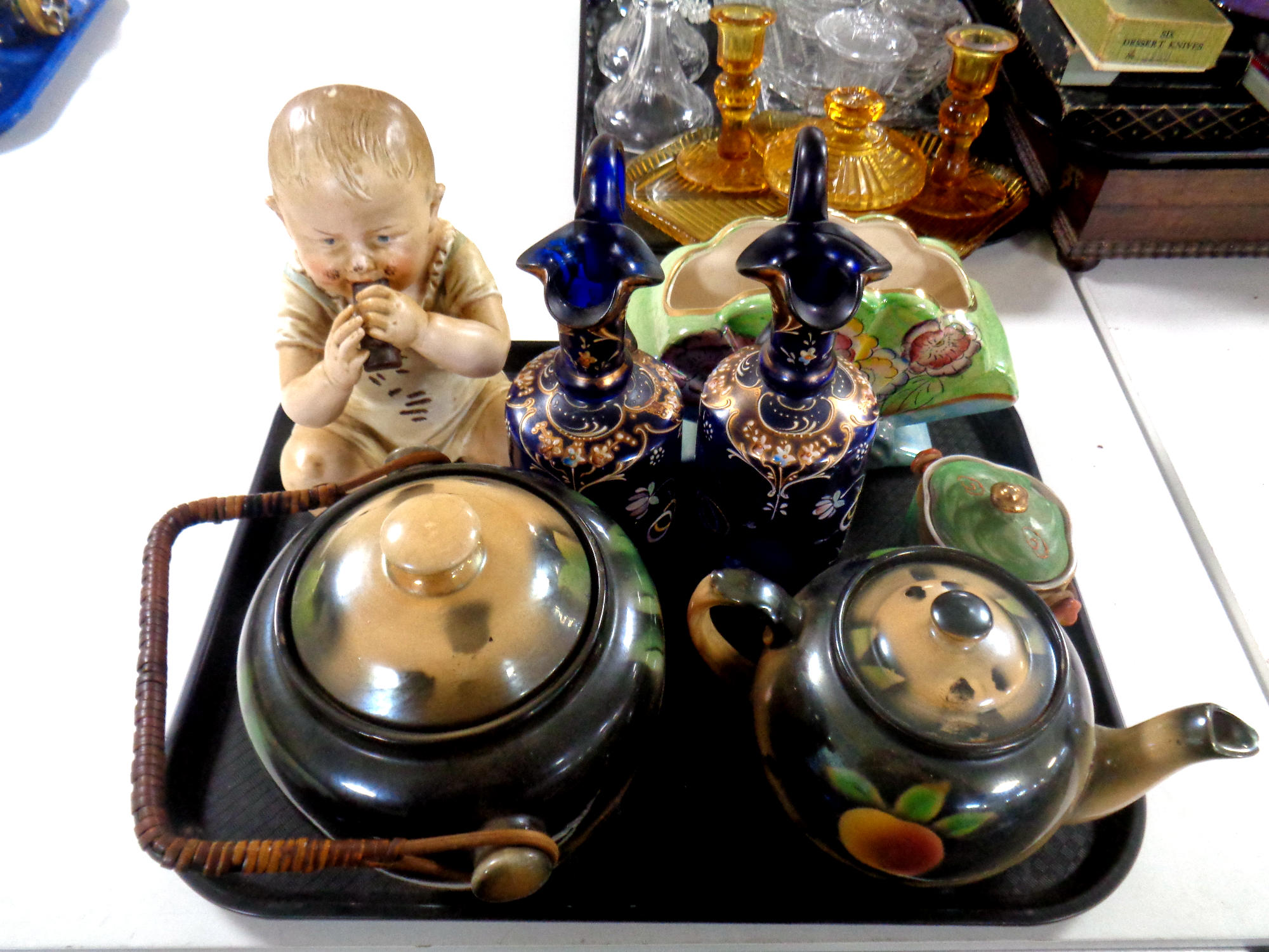 A tray containing miscellany to include German bisque figure of a baby eating chocolate,