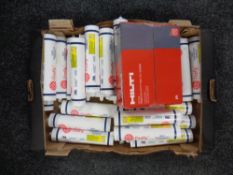 A box of fire fly high temperature adhesive tubes together with a box of Hilti fire stop putty pads