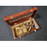 A wooden tool box containing vintage hand tools to include chisel sets, hammers,