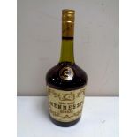A vintage bottle of Hennessey Cognac together with a Courvoisier Cognac miniature in the form of a