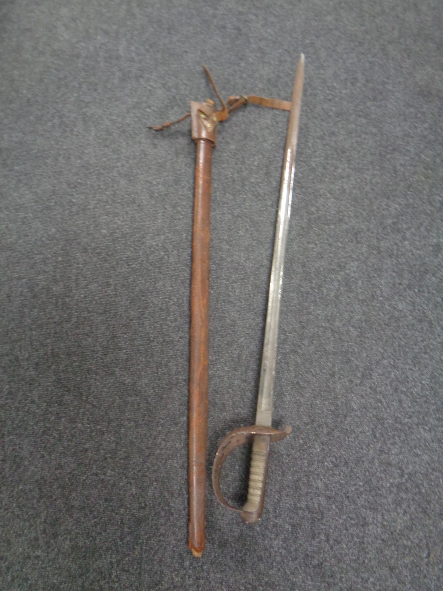 A British 1896 pattern heavy cavalry sword by Sandilands & Son of London, in leather scabbard.