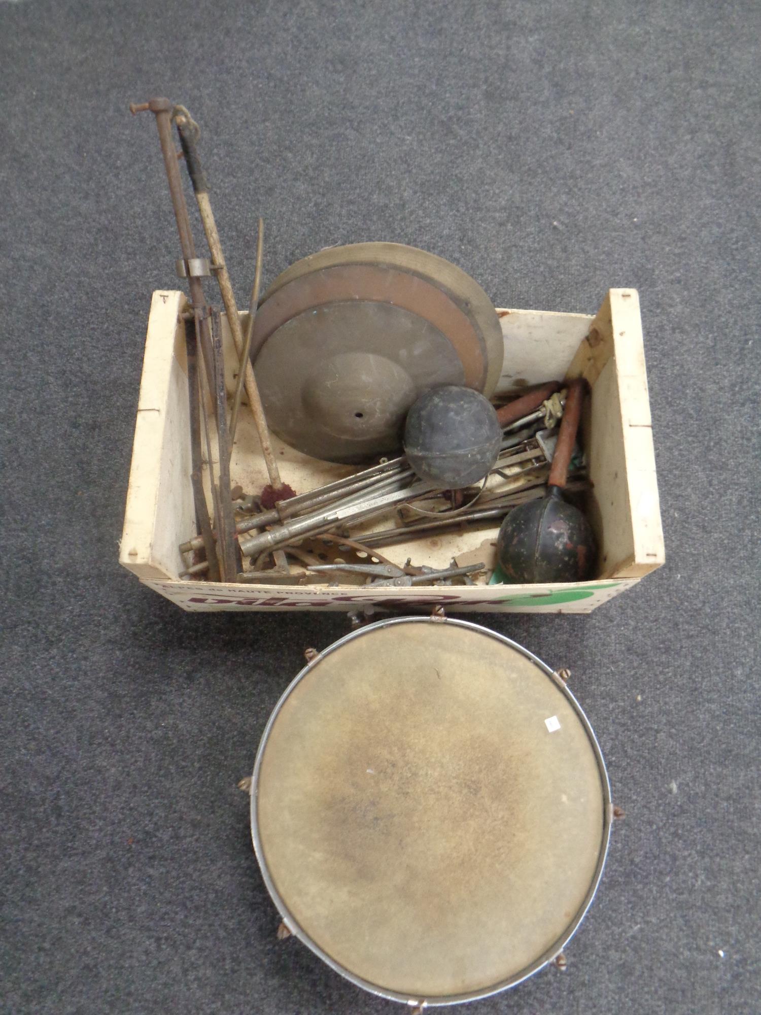 A box containing vintage snare drum with cymbals and stands together with a pair of maracas