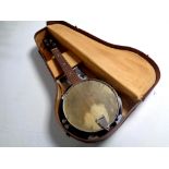 A Melody Junior banjo in case.