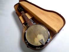 A Melody Junior banjo in case.