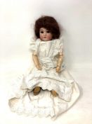 A German bisque-headed doll stamped Gbr 165K 11/2 Germany