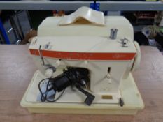 A cased Singer Stylist electric sewing machine.