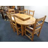 A good quality contemporary oak oval extending table with two leaves together with a set of six