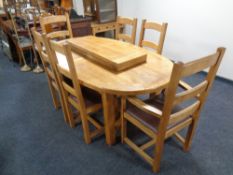A good quality contemporary oak oval extending table with two leaves together with a set of six