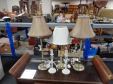 A brass table lamp with shade together with two further pairs of table lamps, one with shades.