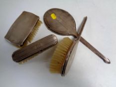 A four piece silver backed dressing table set.