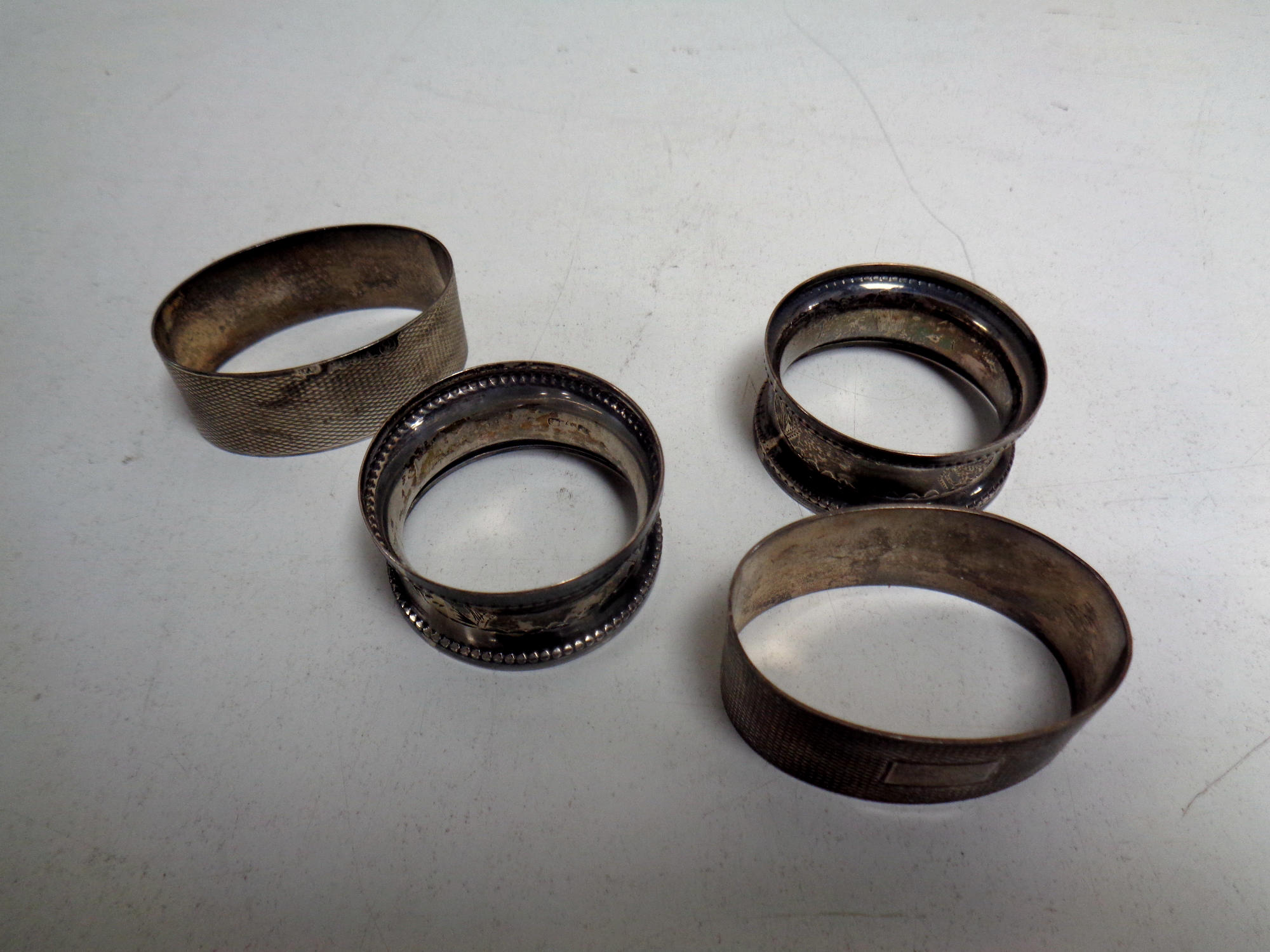 Two pairs of silver napkin rings
