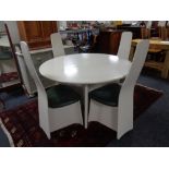 A circular mid century extending table on pedestal together with four high backed chairs