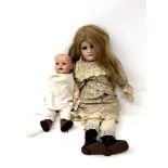 An Armand Marseille bisque headed doll (eyes loose in head),