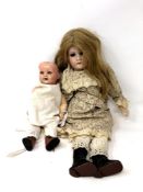 An Armand Marseille bisque headed doll (eyes loose in head),