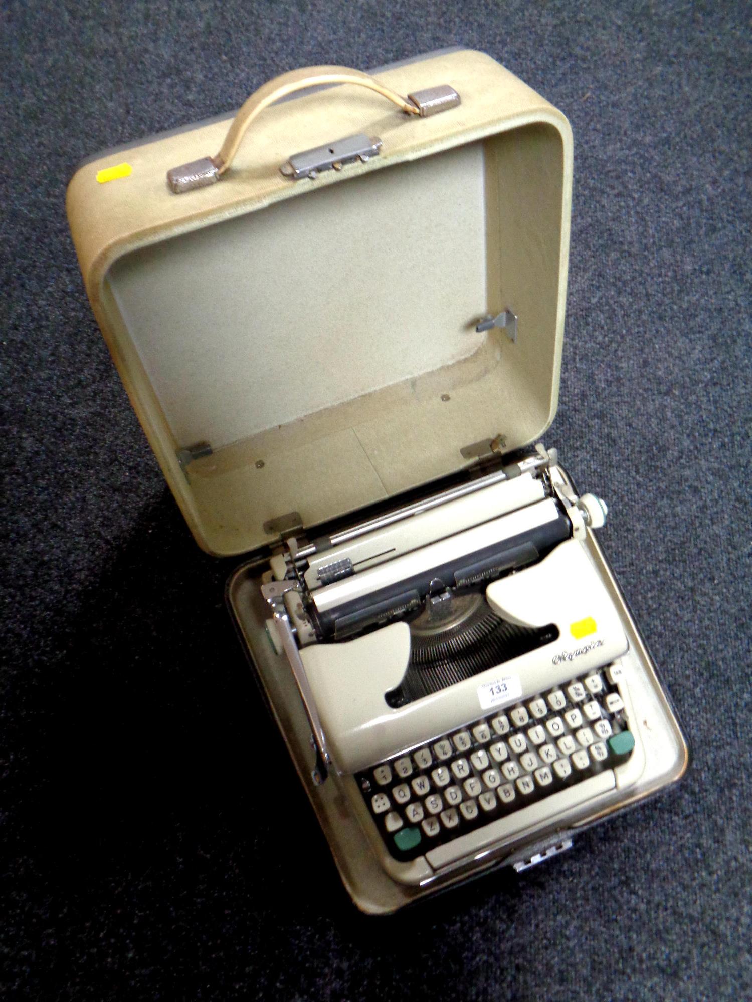 A cased vintage Olympia typewriter.