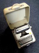 A cased vintage Olympia typewriter.