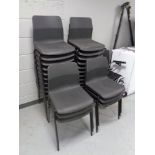 A set of twenty six black plastic stacking chairs