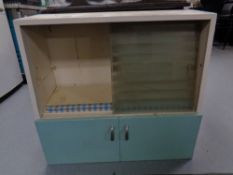 A mid 20th century sliding glass door kitchen wall cabinet fitted cupboard beneath.