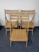A set of eight folding kitchen chairs.