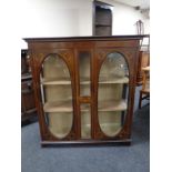 A late nineteenth century inlaid mahogany double display cabinet with later shelves