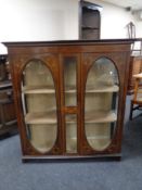 A late nineteenth century inlaid mahogany double display cabinet with later shelves