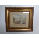 An antiquarian watercolour depicting a boat on beach, in gilt frame.