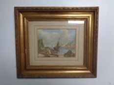 An antiquarian watercolour depicting a boat on beach, in gilt frame.