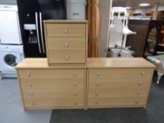 A pair of contemporary pine effect four drawer chests with matching bedside and similar bookshelves