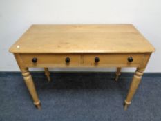 A Victorian pine side table fitted with two drawers