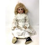 A German bisque-headed doll stamped Revalo.