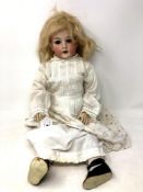 A German bisque-headed doll stamped Revalo.