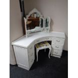 A cream and gilt corner dressing table with triple mirror and stool