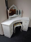 A cream and gilt corner dressing table with triple mirror and stool