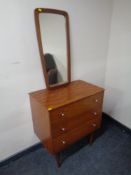 A mid 20th century teak three drawer chest together with a teak wall mirror.