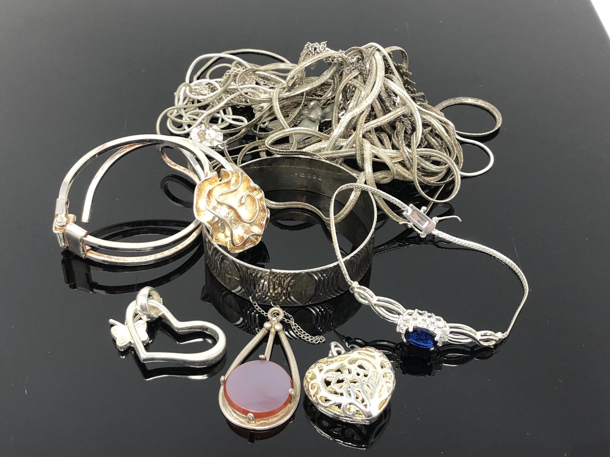 A collection of silver and white metal jewellery